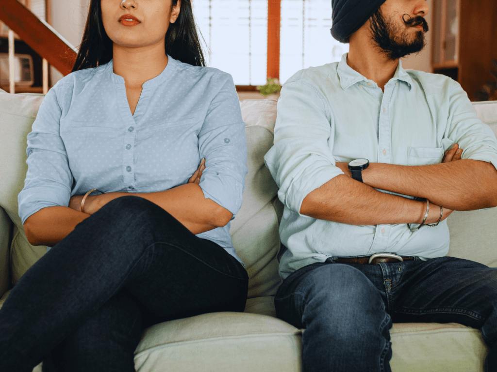 husband and wife sitting apart representing emotional distance in Christian marriage